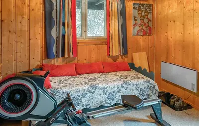a bedroom with a bed and a tv in it at Lovely Home In Lena With Wifi