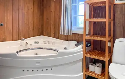 a bathroom with a tub and a toilet and a sink at Nice Home In Oppdal With Sauna in Oppdal