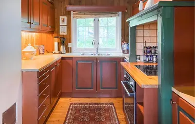 a kitchen with wooden cabinets and a sink at Nice Home In Oppdal With Sauna in Oppdal
