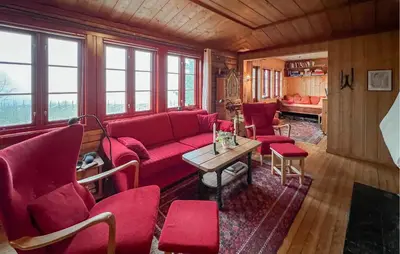 a living room with a red couch and chairs at Awesome Home In Lillehammer With Sauna in Lillehammer