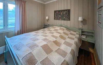 a bedroom with a large bed and a window at Awesome Home In Lillehammer With Sauna in Lillehammer