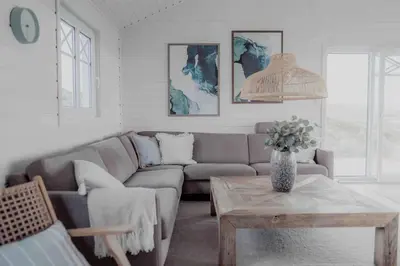 a living room with a couch and a table at Paradise by the Seaside in Hitra
