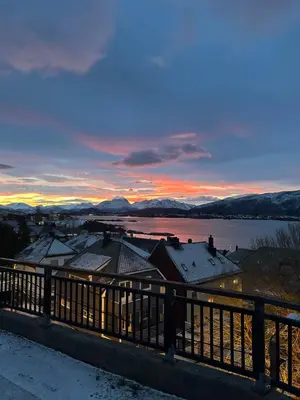 a view of a city in the snow at sunset at Historical house with view and separate entrance in Ålesund