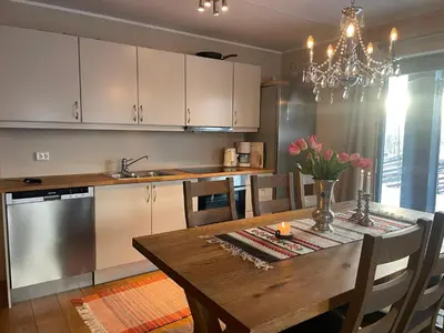 a kitchen with a wooden table and a dining room at A Family-Friendly, Pet-Friendly Getaway In Beitostølen Center in Beitostøl