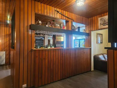 a bar in a room with wooden walls at Eides Hotel in Høyanger