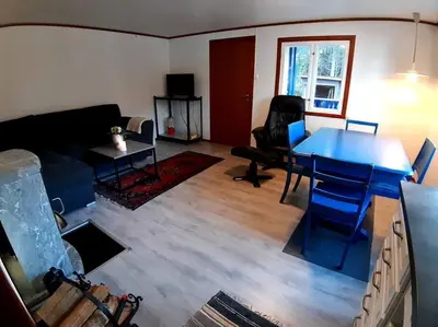 a living room with a blue table and a couch at Koselig blått hus - utsikt Losna in Tretten