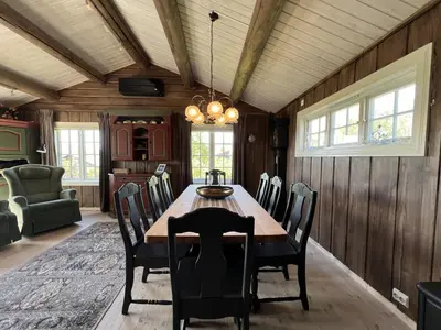 a dining room with a wooden table and chairs at Welcoming Cabin With Fireplace & Modern Kitchen in Beitostøl