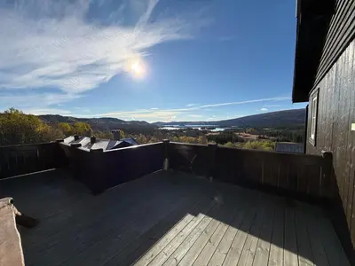 a deck with a view of the mountains at Charming Getaway ,Near Ski Trails And Hiking Paths in Beitostøl
