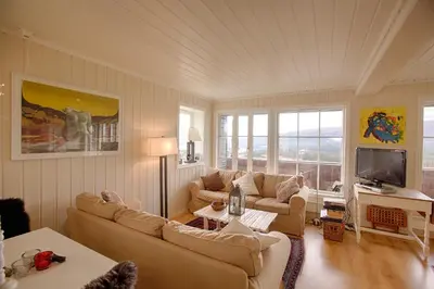 a living room with two couches and a tv at Charming Getaway ,Near Ski Trails And Hiking Paths in Beitostøl
