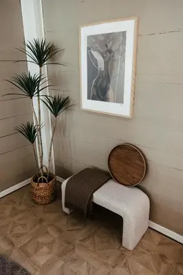 a bench with a table and two plants in a room at Huset Vårt - Bed and Breakfast in Hornindal