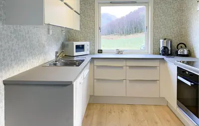 a kitchen with a sink and a microwave at 3 Bedroom Nice Home In Mjosundet in Ertvåg