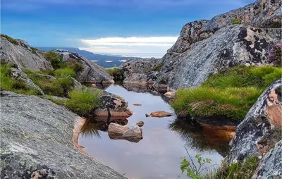 a river between two large rocks on a mountain at 3 Bedroom Nice Home In Mjosundet in Ertvåg