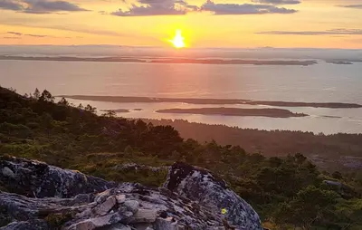 a sunset from the top of a mountain at 3 Bedroom Nice Home In Mjosundet in Ertvåg