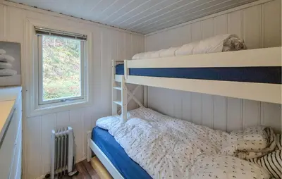 a bedroom with a bunk bed and a window at Amazing Home In Omastrand With Wifi in Gjuvsland