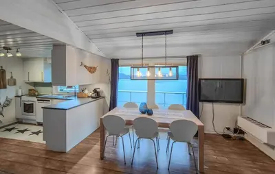 a kitchen with a table and chairs in a room at Amazing Home In Omastrand With Wifi in Gjuvsland