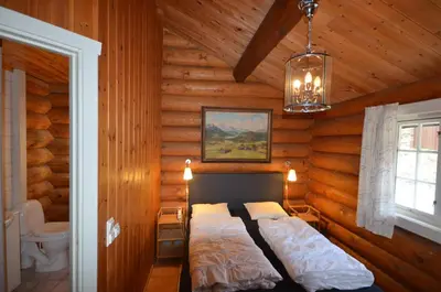 a bedroom with a bed in a log cabin at Large Cabin with Stunning Views! in Beitostøl
