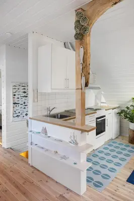 a kitchen with white cabinets and a sink at Exclusive fjord getaway with sauna in Leirgulen