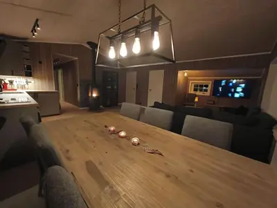 a large wooden table in a living room at Hytte-23 Cozy cabin close to Kvitfjell in Fåvang