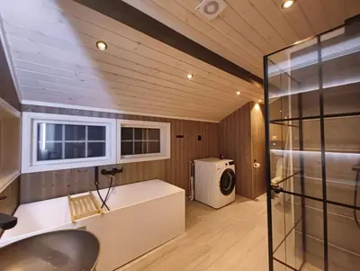 a bathroom with a sink and a washing machine at Hytte-23 Cozy cabin close to Kvitfjell in Fåvang