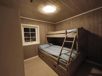 a small room with a bunk bed and a window at Hytte-23 Cozy cabin close to Kvitfjell in Fåvang
