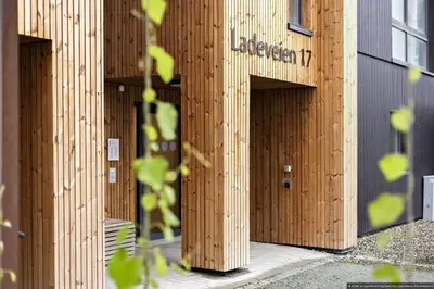 a building with wooden panels on the side of it at Eksklusiv byleilighet med utsikt i Trondheim Sentrum in Trondheim