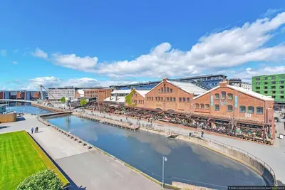 a view of a city with a river and buildings at Eksklusiv byleilighet med utsikt i Trondheim Sentrum in Trondheim