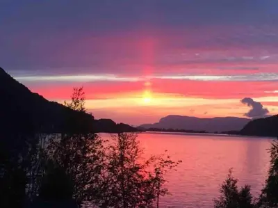 a sunset over a body of water at Oceanview House Ideal for Peaceful Holidays in Venøya