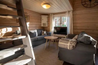 a living room with a couch and a table at Vikinggrenda 21B in Trysil