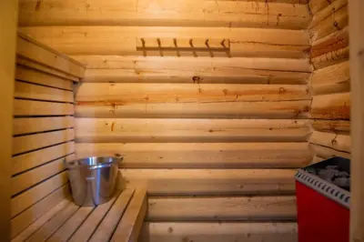 a wooden sauna with a bucket in it at Vikinggrenda 21B in Trysil
