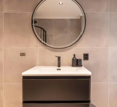 a bathroom with a sink and a mirror at DINBNB Apartments l 50 meters to Bryggen l New 2023 l Sunny backyard in Bergen