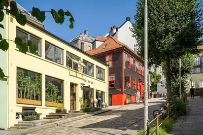 a group of buildings on a city street at DINBNB Apartments l 50 meters to Bryggen l New 2023 l Sunny backyard in Bergen