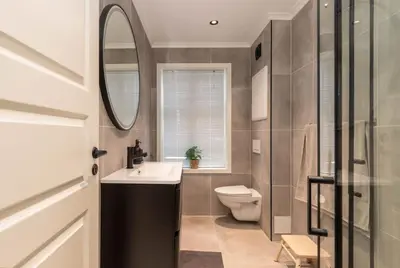 a bathroom with a toilet and a sink and a mirror at DINBNB Apartments l 50 meters to Bryggen l New 2023 l Sunny backyard in Bergen