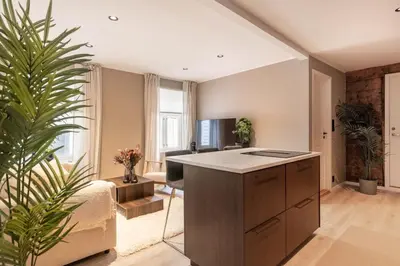 a kitchen with a island in the middle of a room at DINBNB Apartments l 50 meters to Bryggen l New 2023 l Sunny backyard in Bergen