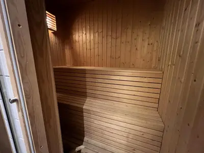 a wooden sauna with a wooden step in it at Cozy Getaway Sauna and Terrace in Beitostøl