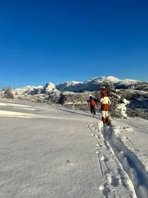 two people walking down a road in the snow at Panorama ski inn out, jacuzzi,Badstu in Kvam