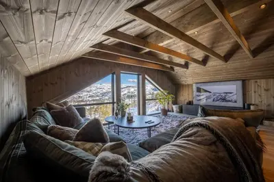 a living room with a couch and a table at Panorama ski inn out, jacuzzi,Badstu in Kvam