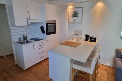a kitchen with white cabinets and a counter top at Central 1 bedroom apartment with a view in Bergen