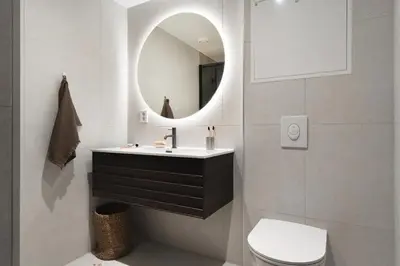 a bathroom with a sink and a mirror at Stay l Nordnes in Bergen