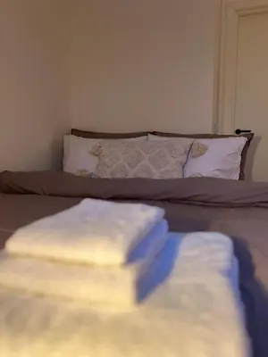 a pile of towels sitting on top of a bed at Apartment in Bergen in Bergen
