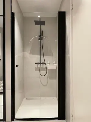 a shower with a glass door in a bathroom at Apartment in Bergen in Bergen