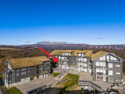 an aerial view of an apartment complex with a red arrow at Kikut Panorama Geilo Ski-in Ski-out in Geilo