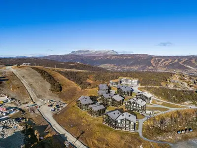 an aerial view of a resort with mountains in the background at Kikut Panorama Geilo Ski-in Ski-out in Geilo