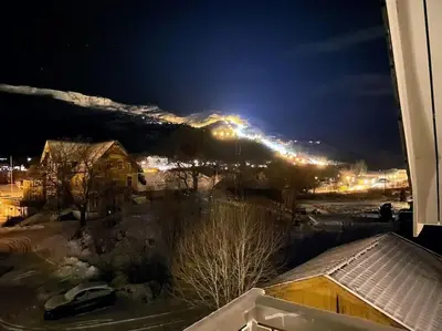 a view of a snow covered mountain at night at Idyllisk hus i Vassenden sentrum in Vassenden