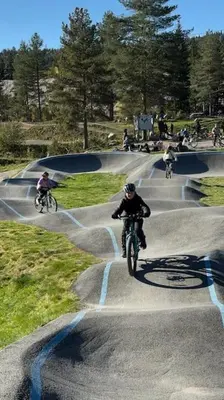 a group of people riding bikes around a skate park at Koselig feriehus med jacuzzi i Nordre Osen, kun 40 minutter fra Trysil skianlegg in Åmot