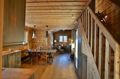 a kitchen and dining room with a table in a cabin at Relaxing Getaway Sauna,Terrace and Pet friendly in Beitostøl