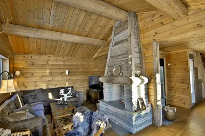 a living room of a log cabin with a fireplace at Relaxing Getaway Sauna,Terrace and Pet friendly in Beitostøl
