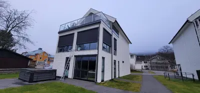 a large white house with a large window at Unique 3-Storey House in Trysil Luxury Living in the Heart of the Village in Trysil