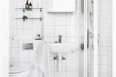 a white bathroom with a toilet and a sink at Ultra central flat with balcony in Bergen