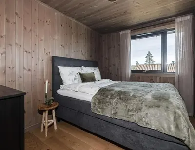 a bedroom with a large bed and a window at Modern cabin with a Mountain View in Nos