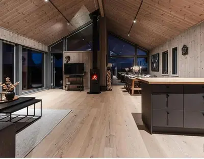 a large living room with a fireplace in the middle at Modern cabin with a Mountain View in Nos